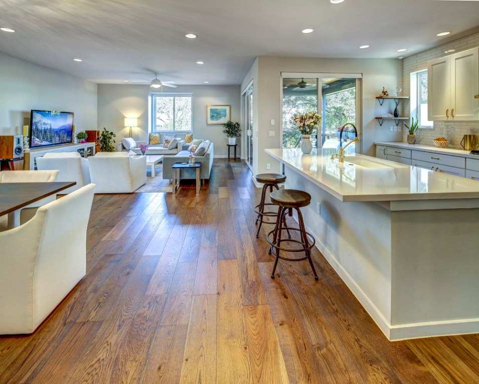 a view of a kitchen and dining room with wooden floor