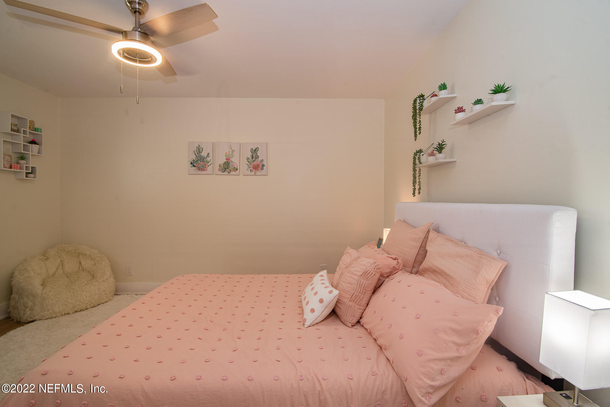 4268 Heath Road Jacksonville, FL 32277 - Photo 25 of 43 a bedroom with a bed and a chandelier