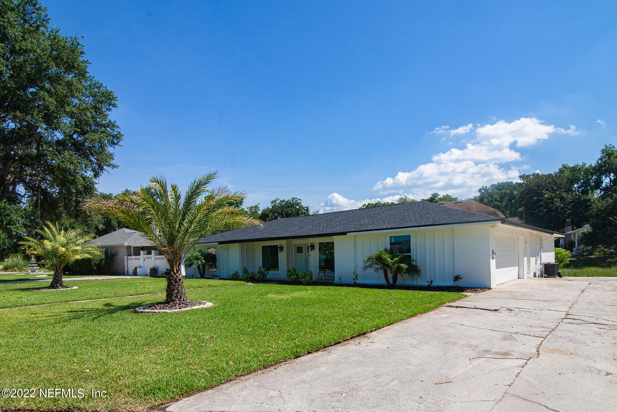 4268 Heath Road Jacksonville, FL 32277 - Photo 4 of 43 a front view of a house with a yard and garage
