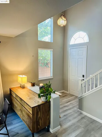 a living room with a bed furniture and a window