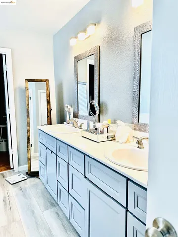a bathroom with a double vanity sink and a mirror