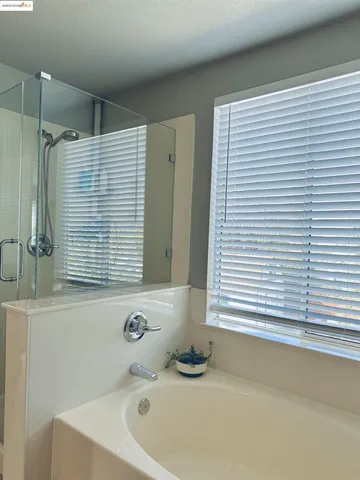 a bathroom with a bathtub and a window