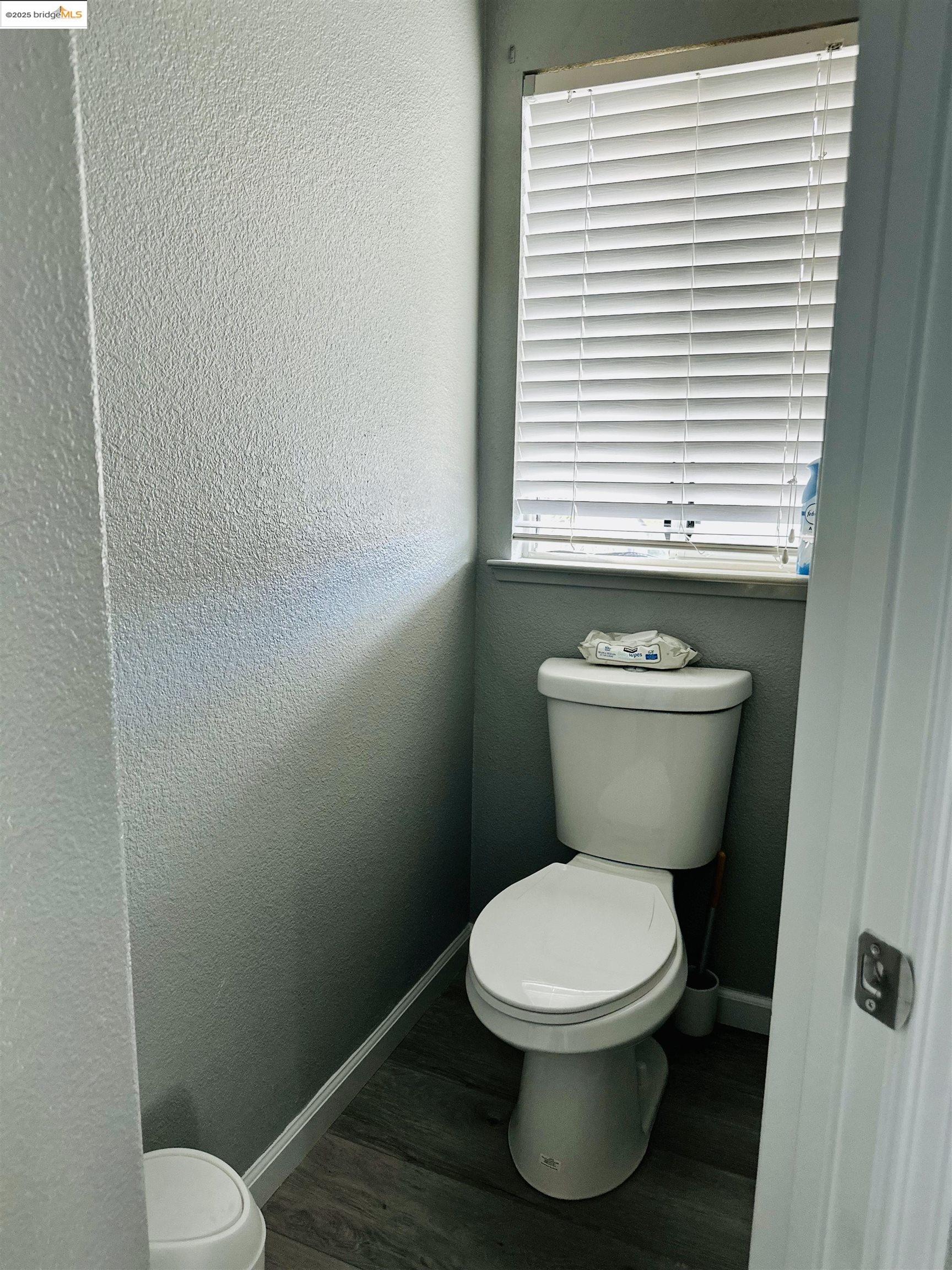 4519 Twin Creeks Court Tracy, CA 95377 - Photo 20 of 34 a white toilet sitting in a bathroom next to a window