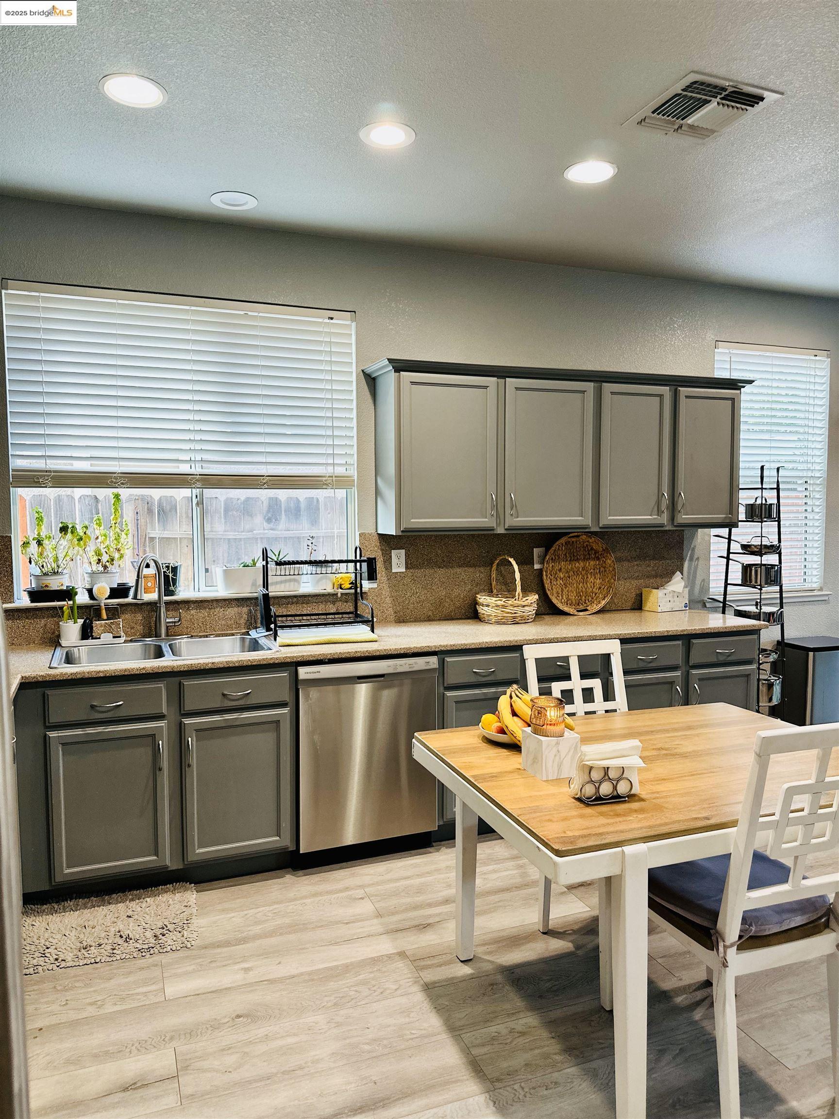 4519 Twin Creeks Court Tracy, CA 95377 - Photo 2 of 34 a kitchen with a table chairs sink and cabinets