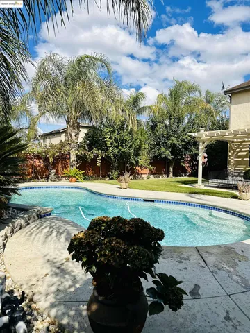 a view of a swimming pool and a yard