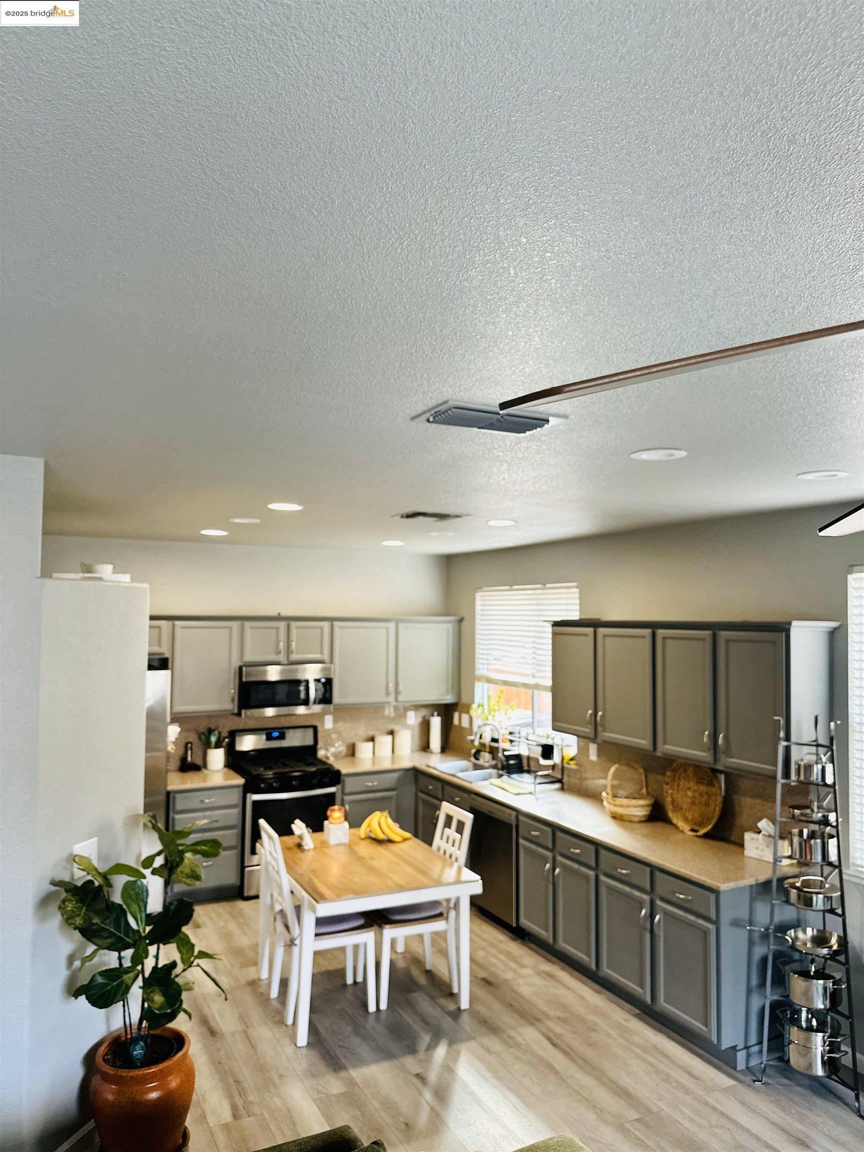4519 Twin Creeks Court Tracy, CA 95377 - Photo 4 of 34 a kitchen with kitchen island granite countertop lots of counter top space and furniture