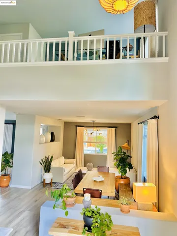 a living room with furniture windows and wooden floor