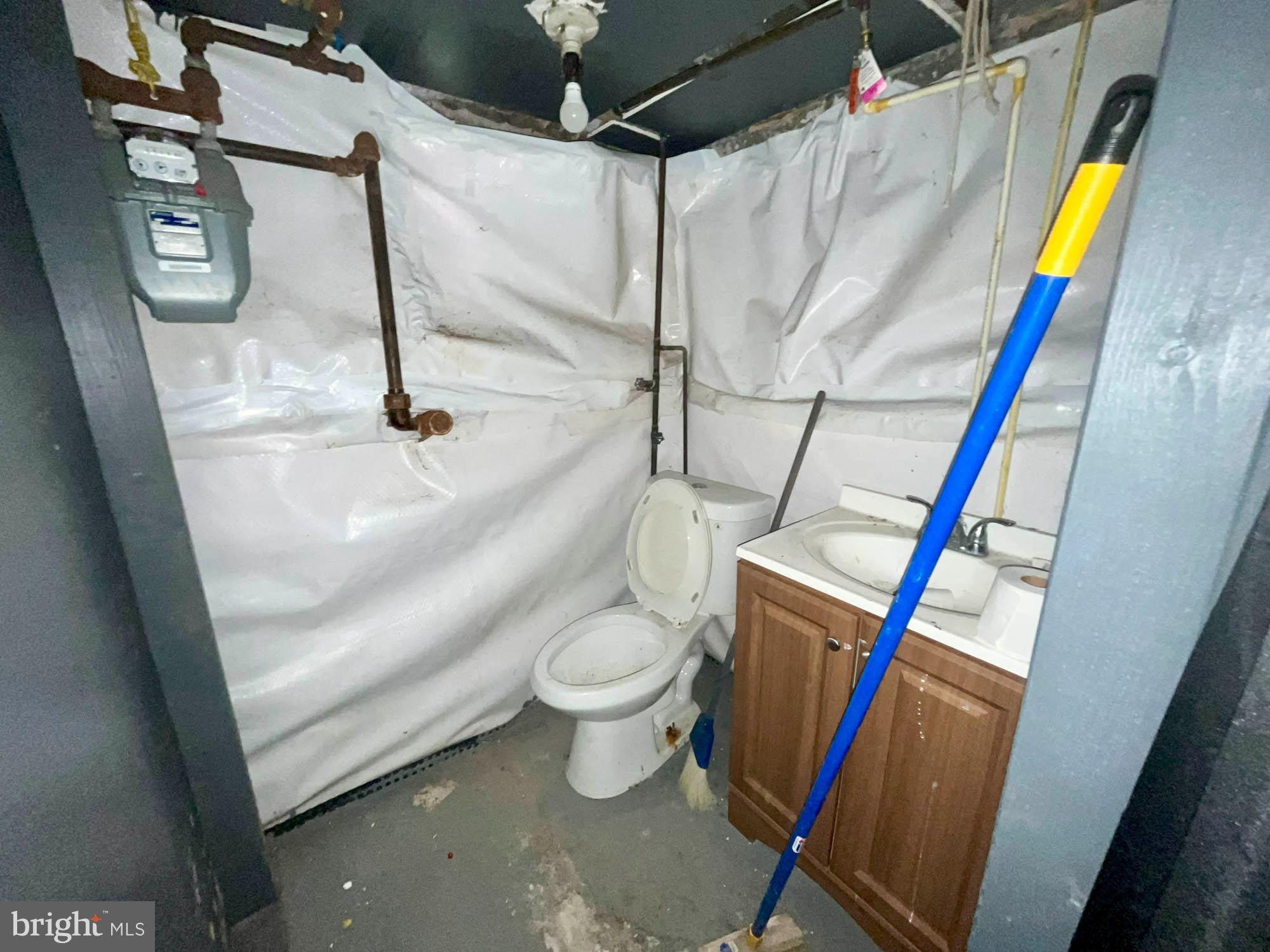 2701 Baker Street Baltimore, MD 21216 - Photo 12 of 16 a bathroom with a sink and toilet