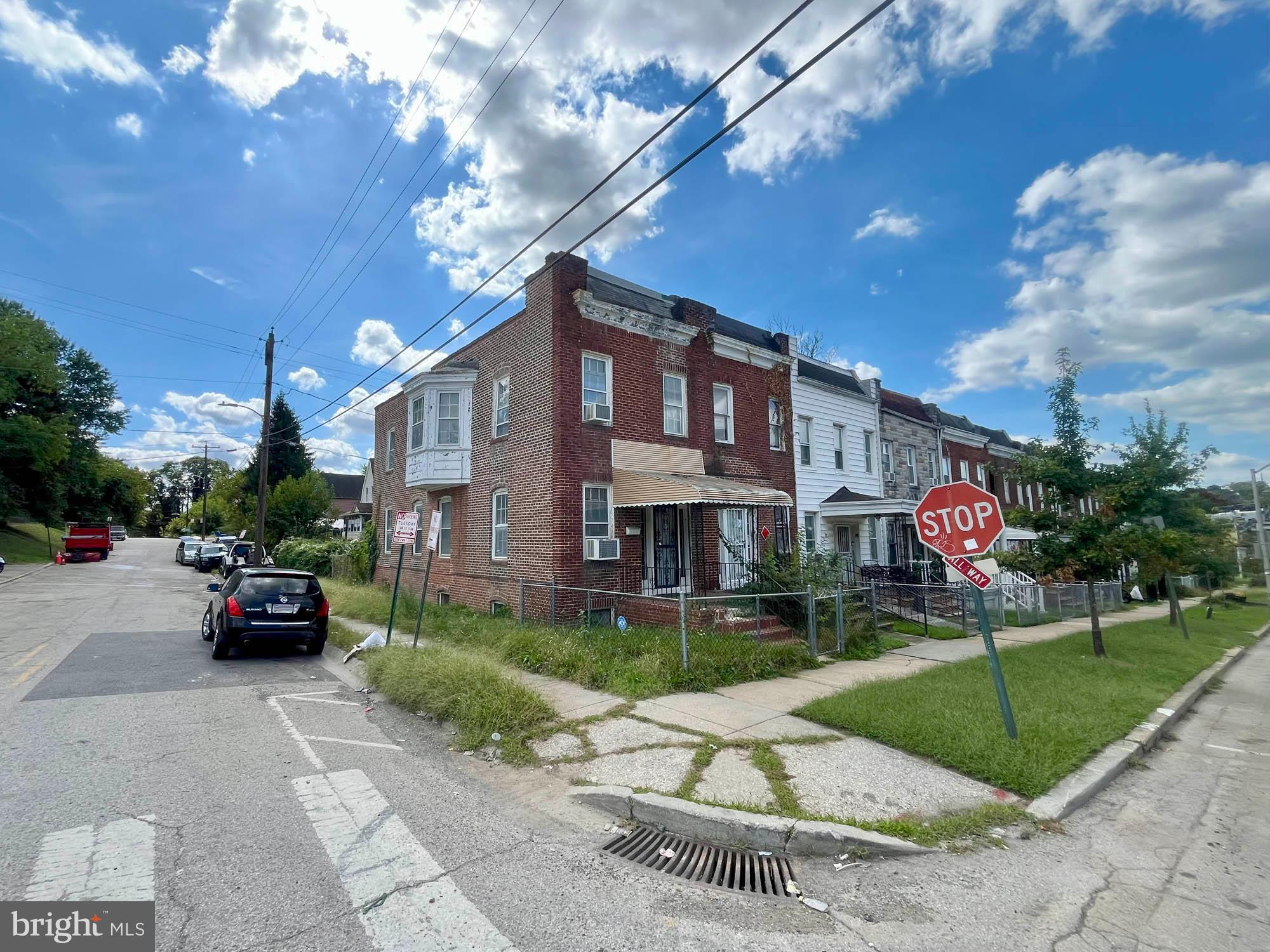 2701 Baker Street Baltimore, MD 21216 - Photo 13 of 16 a view of a building with a yard and plants