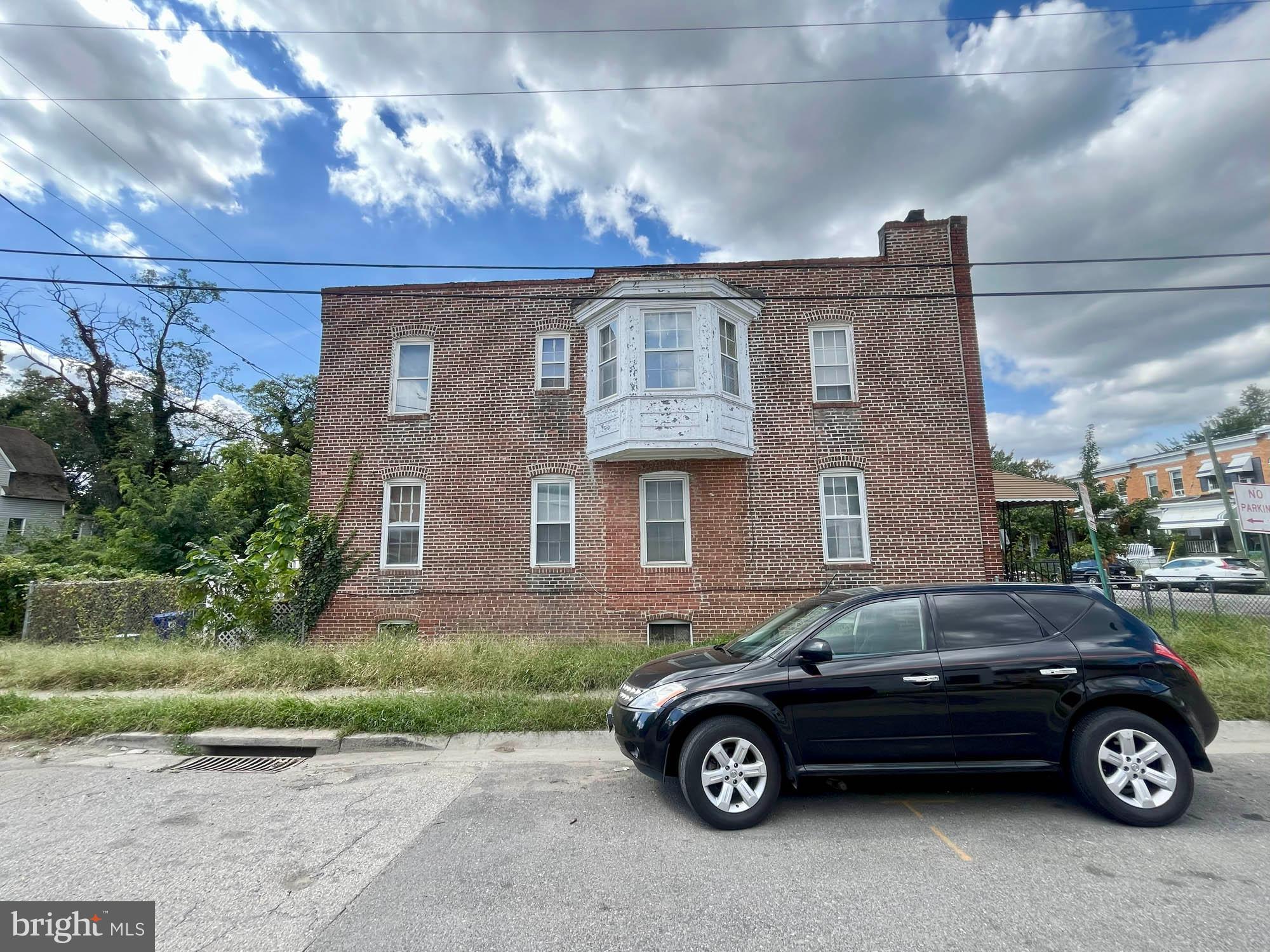 2701 Baker Street Baltimore, MD 21216 - Photo 14 of 16 a car parked in front of a house