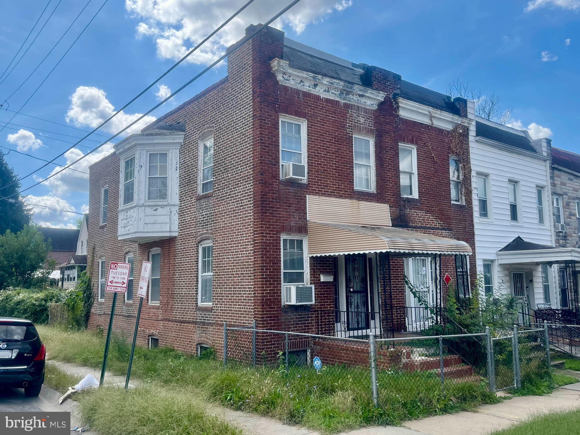 2701 Baker Street Baltimore, MD 21216 - Photo 2 of 16 a view of a brick building with many windows and a yard