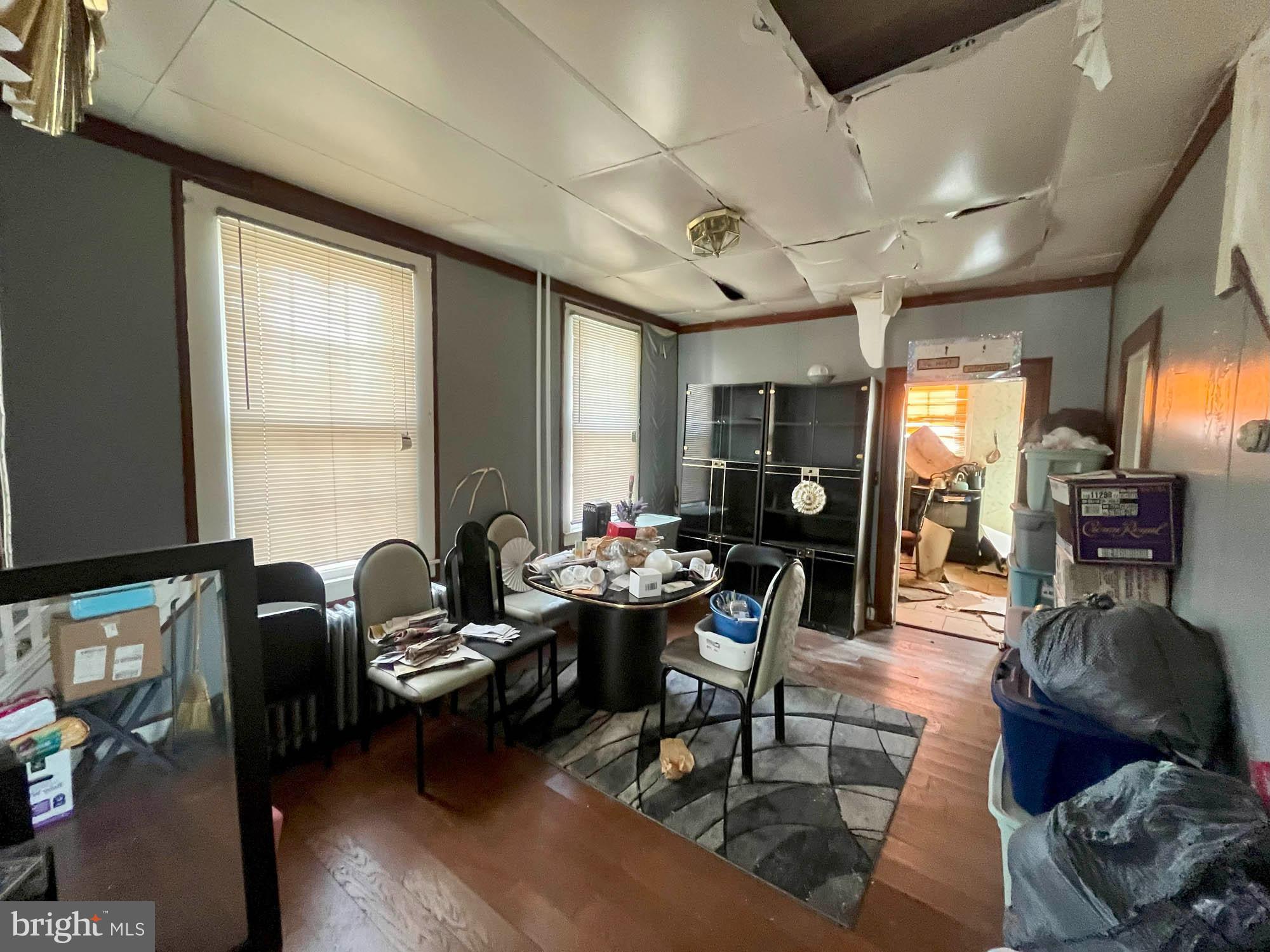 2701 Baker Street Baltimore, MD 21216 - Photo 5 of 16 a living room with furniture and wooden floor