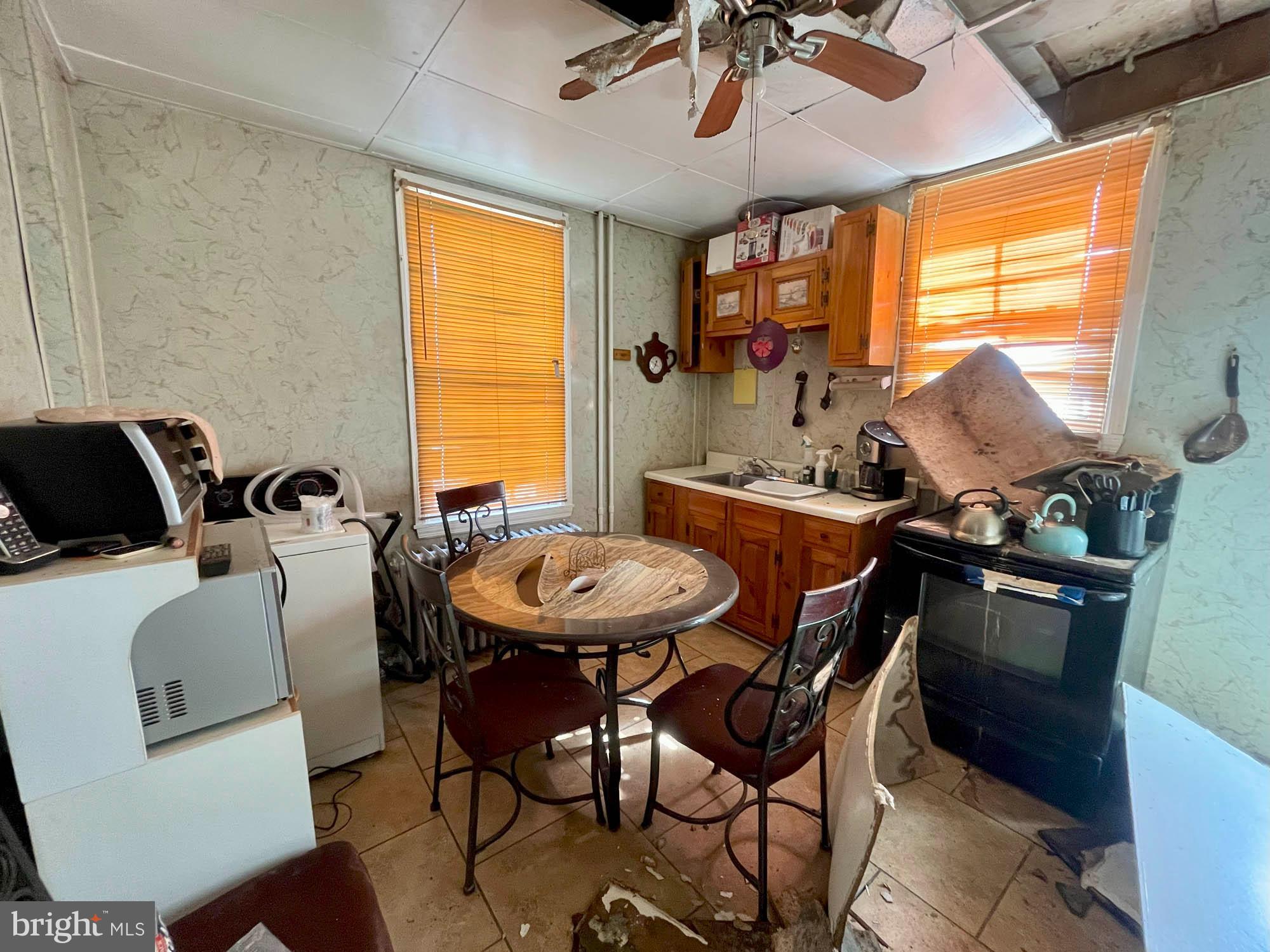 2701 Baker Street Baltimore, MD 21216 - Photo 6 of 16 a view of a dining room with furniture window and outside view
