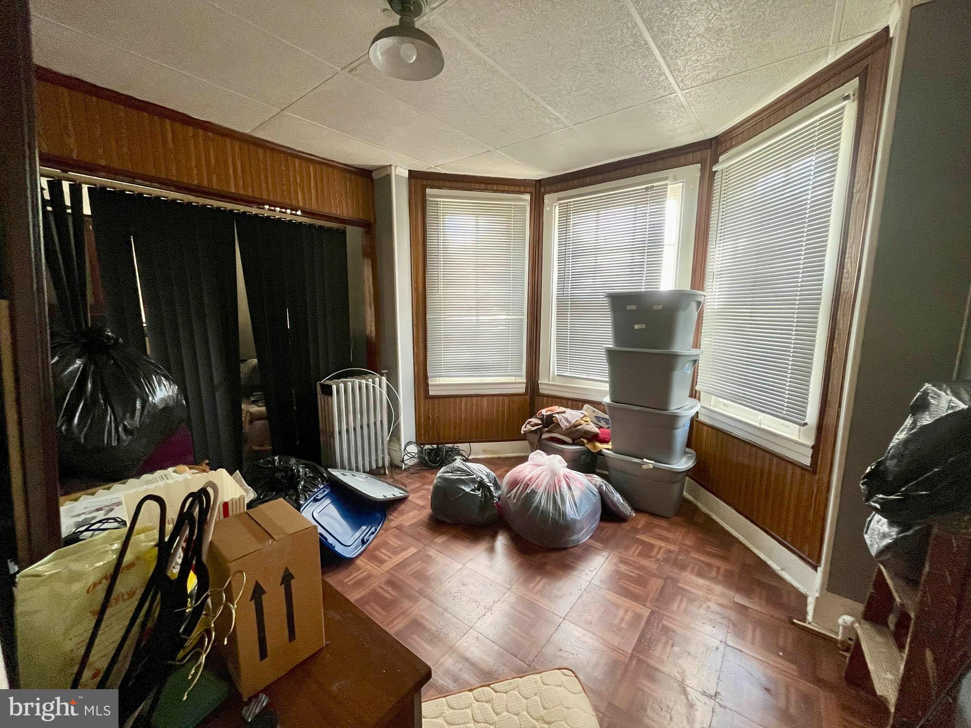 2701 Baker Street Baltimore, MD 21216 - Photo 8 of 16 a living room with furniture and a flat screen tv