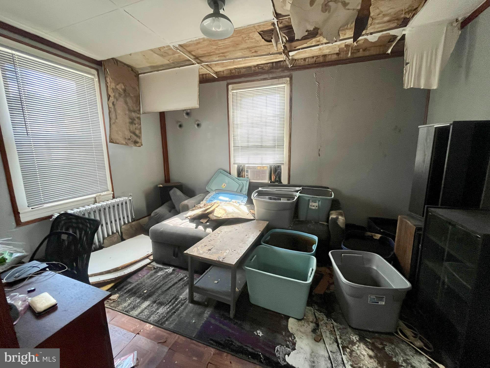 2701 Baker Street Baltimore, MD 21216 - Photo 10 of 16 a living room with furniture and a flat screen tv