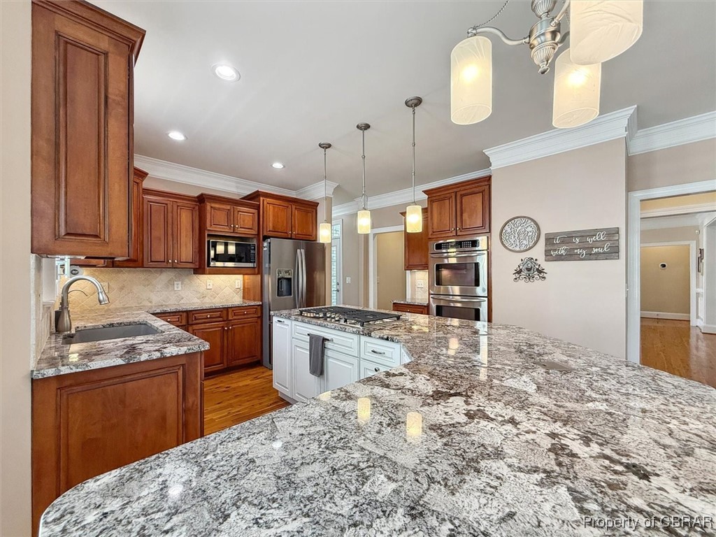 3013 Ridge Drive Toano, VA 23168 - Photo 34 of 50 Kitchen with ornamental molding, stainless steel appliances, light wood finished floors, and a sink