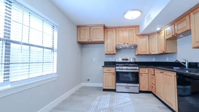a kitchen with stainless steel appliances granite countertop a stove and a sink