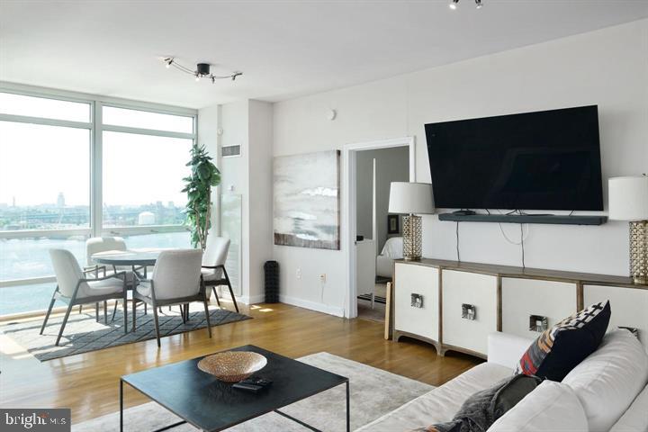 901 North Penn Street, Unit R1501 Philadelphia, PA 19123 - Photo 6 of 25 a living room with furniture and a flat screen tv