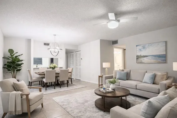 a living room with furniture potted plant and a window