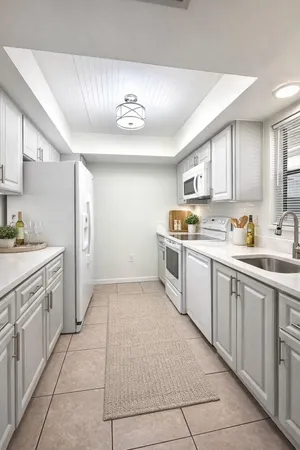 a kitchen with a stove sink and cabinets