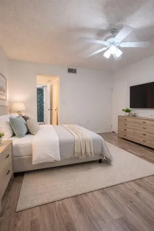 a bedroom with a large bed and a flat screen tv