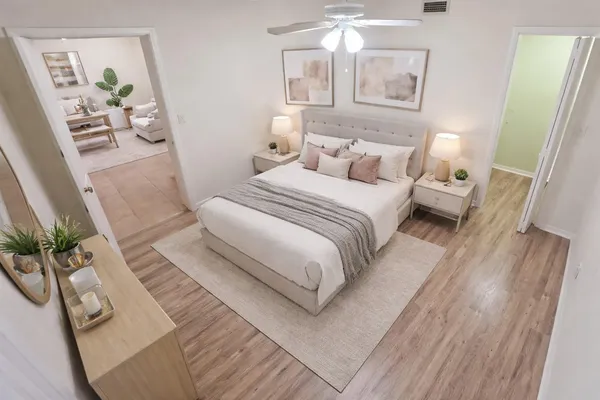 a bedroom with a bed and wooden floor