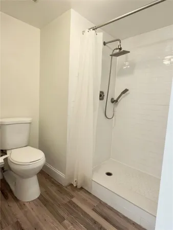 a bathroom with a shower and a toilet