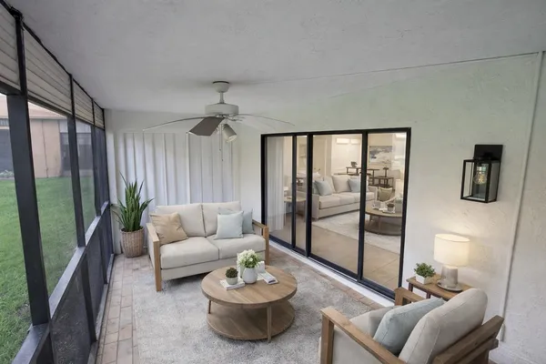 a living room with furniture and a floor to ceiling window