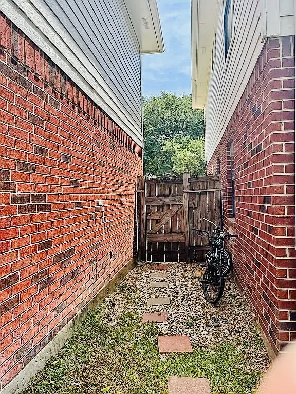 8606 Prima Street Houston, TX 77083 - Photo 29 of 32 Side view of home gate entrance to backyard
