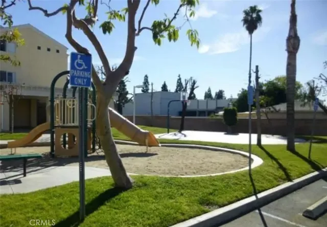 a view of a swimming pool with a bench and trees