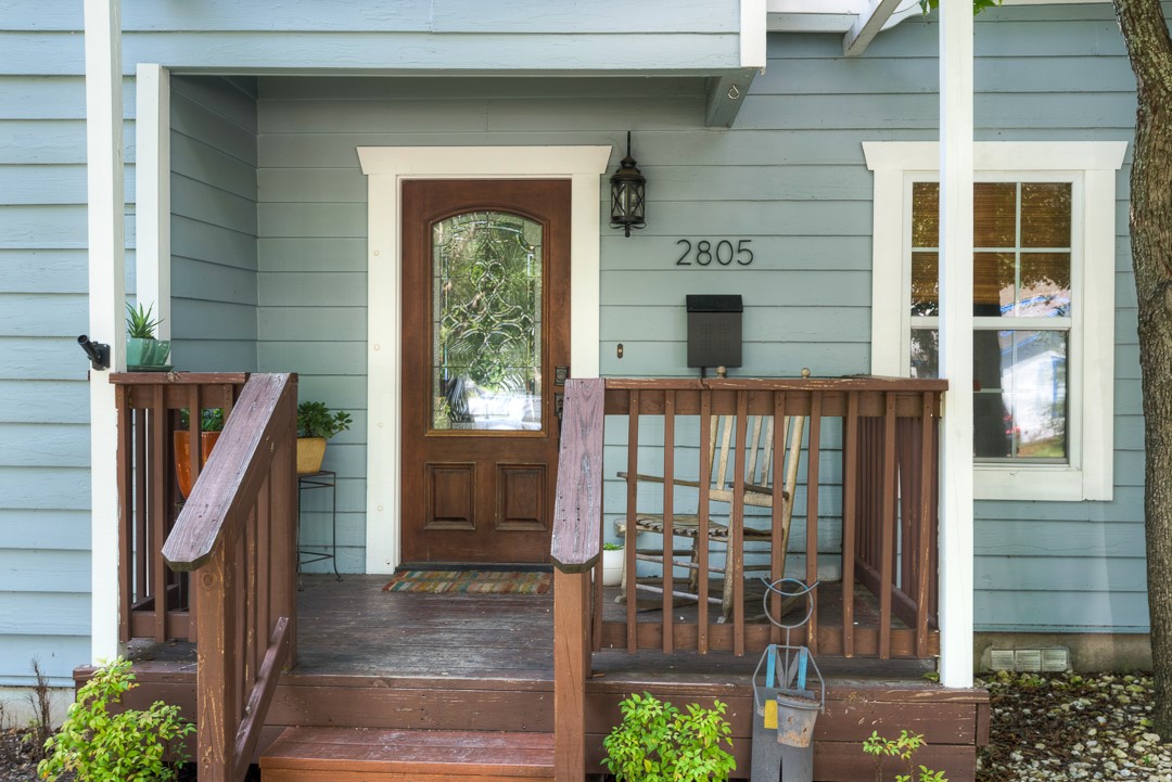 View of exterior entry featuring covered porch