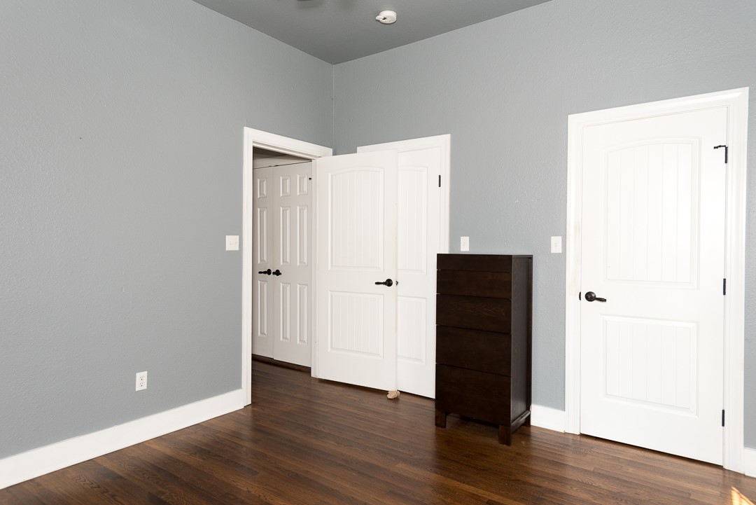 2805 Lafayette Avenue Austin, TX 78722 - Photo 5 of 23 Unfurnished bedroom featuring dark wood-style floors and baseboards