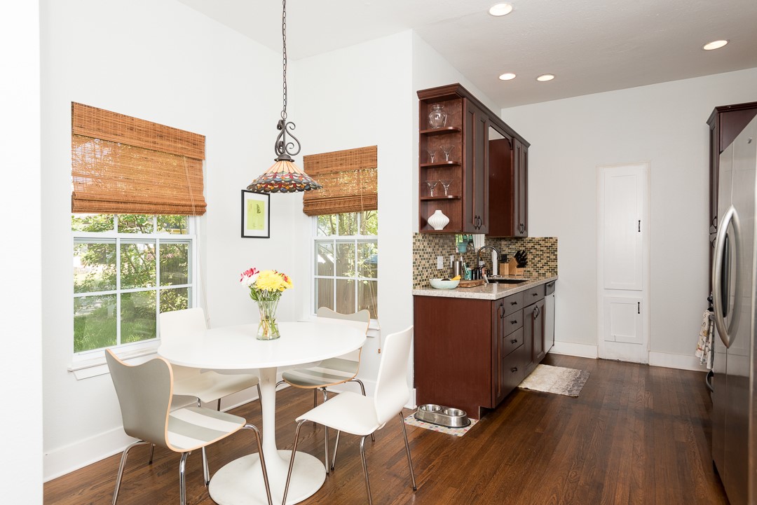 2805 Lafayette Avenue Austin, TX 78722 - Photo 8 of 23 Kitchen with open shelves, dark wood-type flooring, freestanding refrigerator, healthy amount of natural light, and recessed lighting