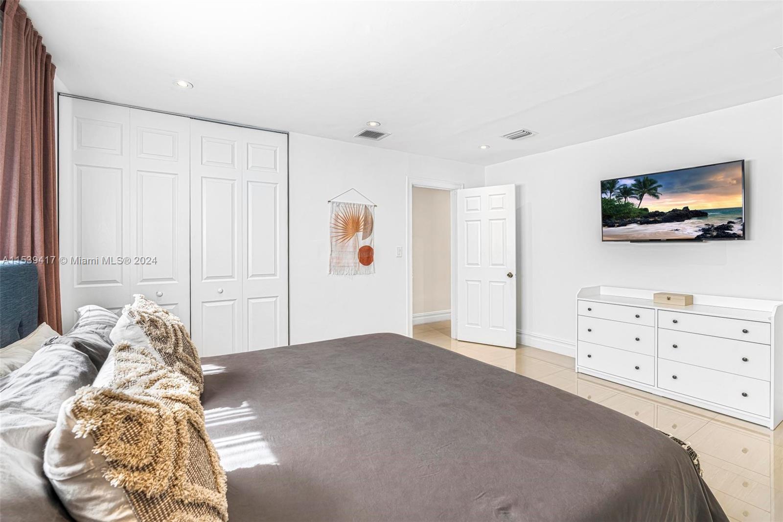 1301 Southwest 99th Court Miami, FL 33174 - Photo 17 of 35 a bedroom with a bed and a flat screen tv