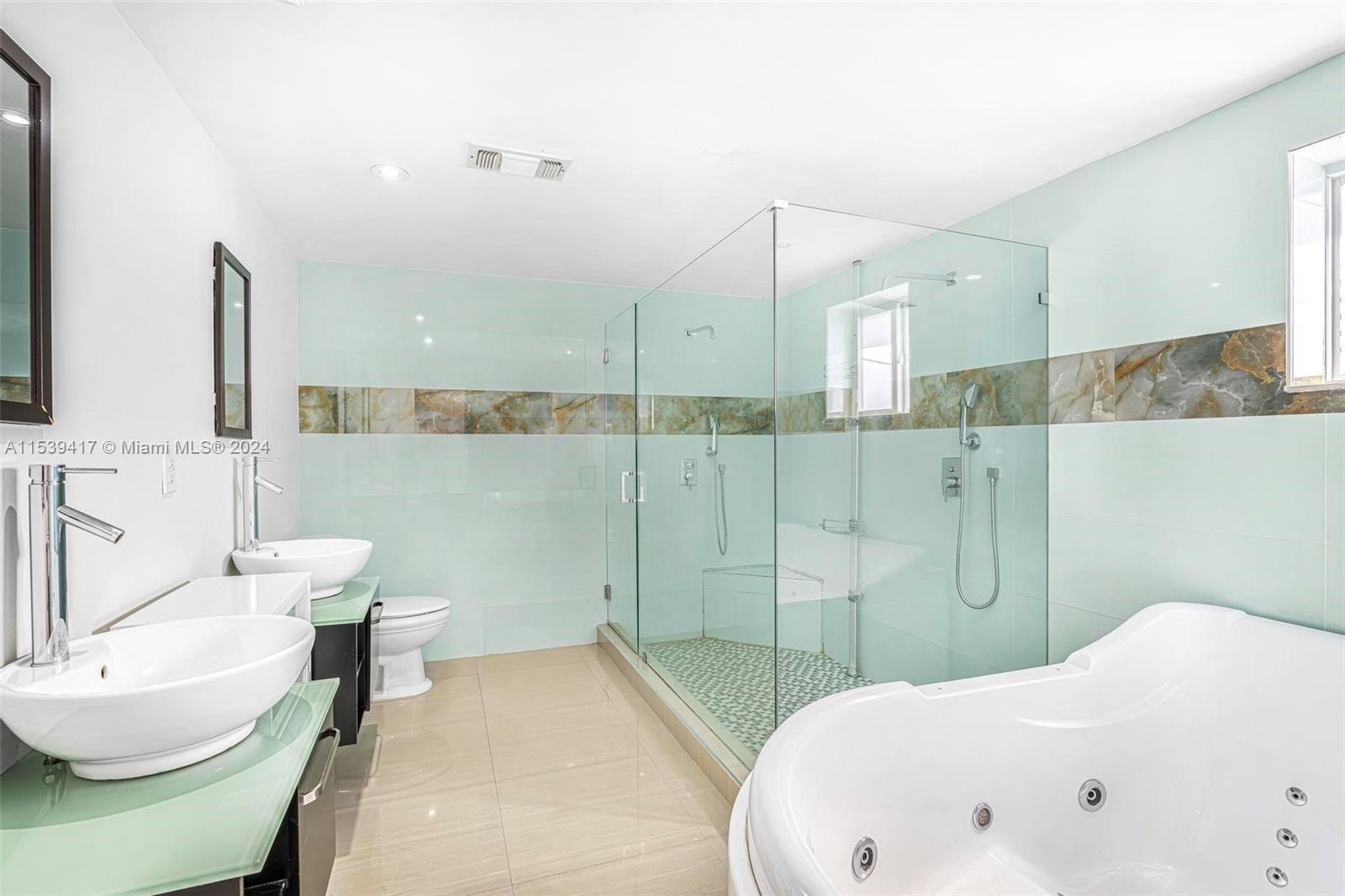 1301 Southwest 99th Court Miami, FL 33174 - Photo 18 of 35 a bathroom with a bathtub and a toilet