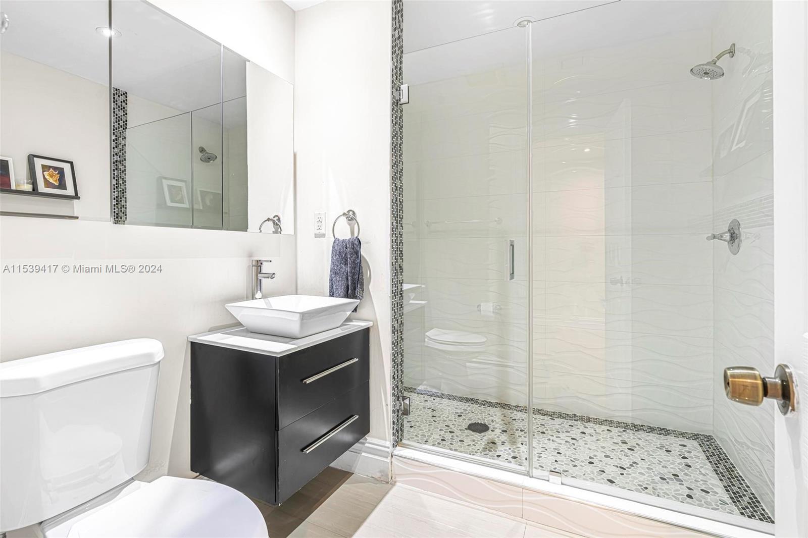1301 Southwest 99th Court Miami, FL 33174 - Photo 19 of 35 a bathroom with a sink toilet and shower