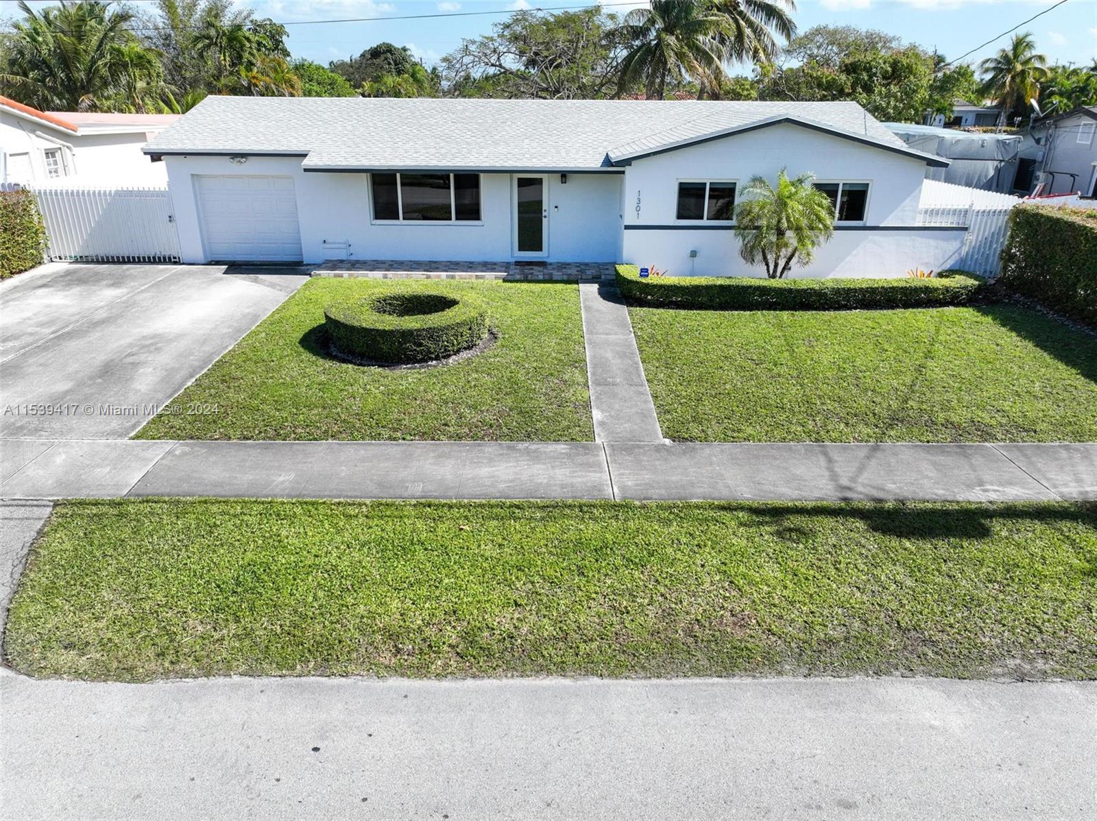 1301 Southwest 99th Court Miami, FL 33174 - Photo 2 of 35 a front view of a house with garden