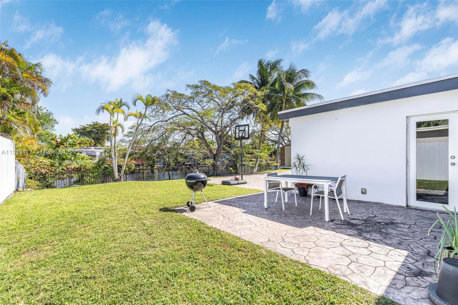 1301 Southwest 99th Court Miami, FL 33174 - Photo 24 of 35 a view of a backyard with table and chairs