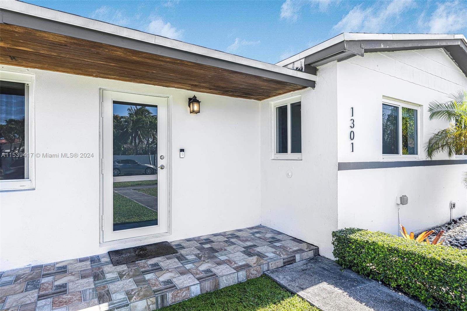 1301 Southwest 99th Court Miami, FL 33174 - Photo 4 of 35 a front view of a house with a yard