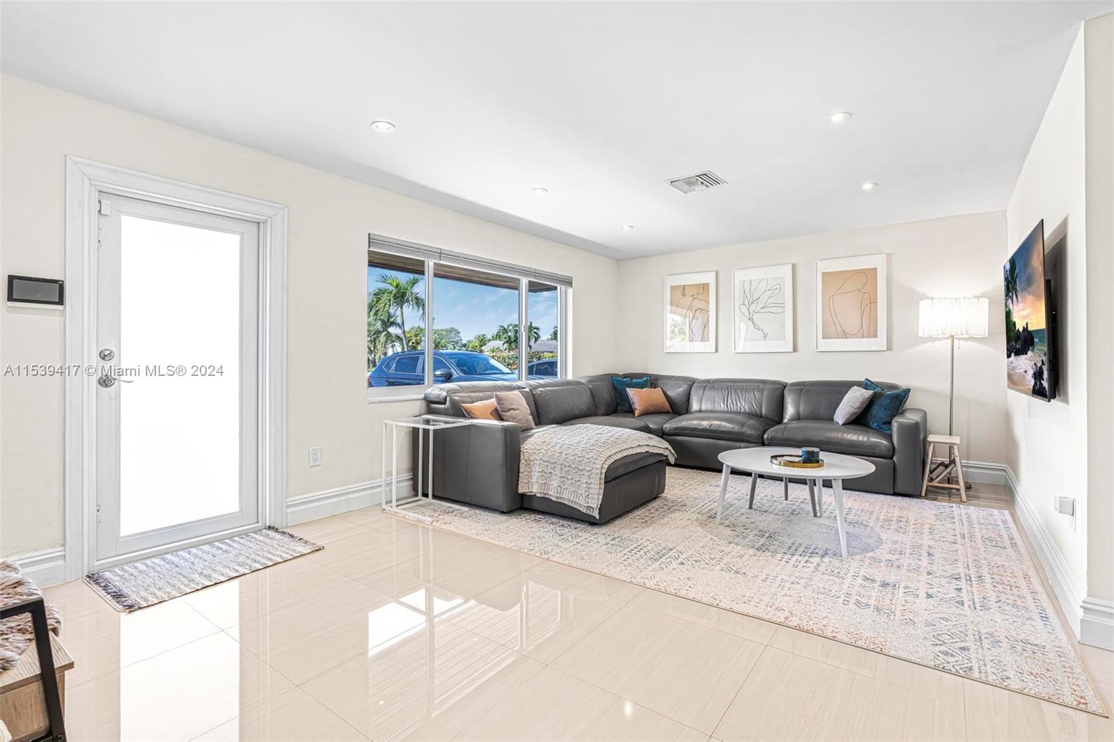 1301 Southwest 99th Court Miami, FL 33174 - Photo 7 of 35 a living room with furniture a flat screen tv and a window