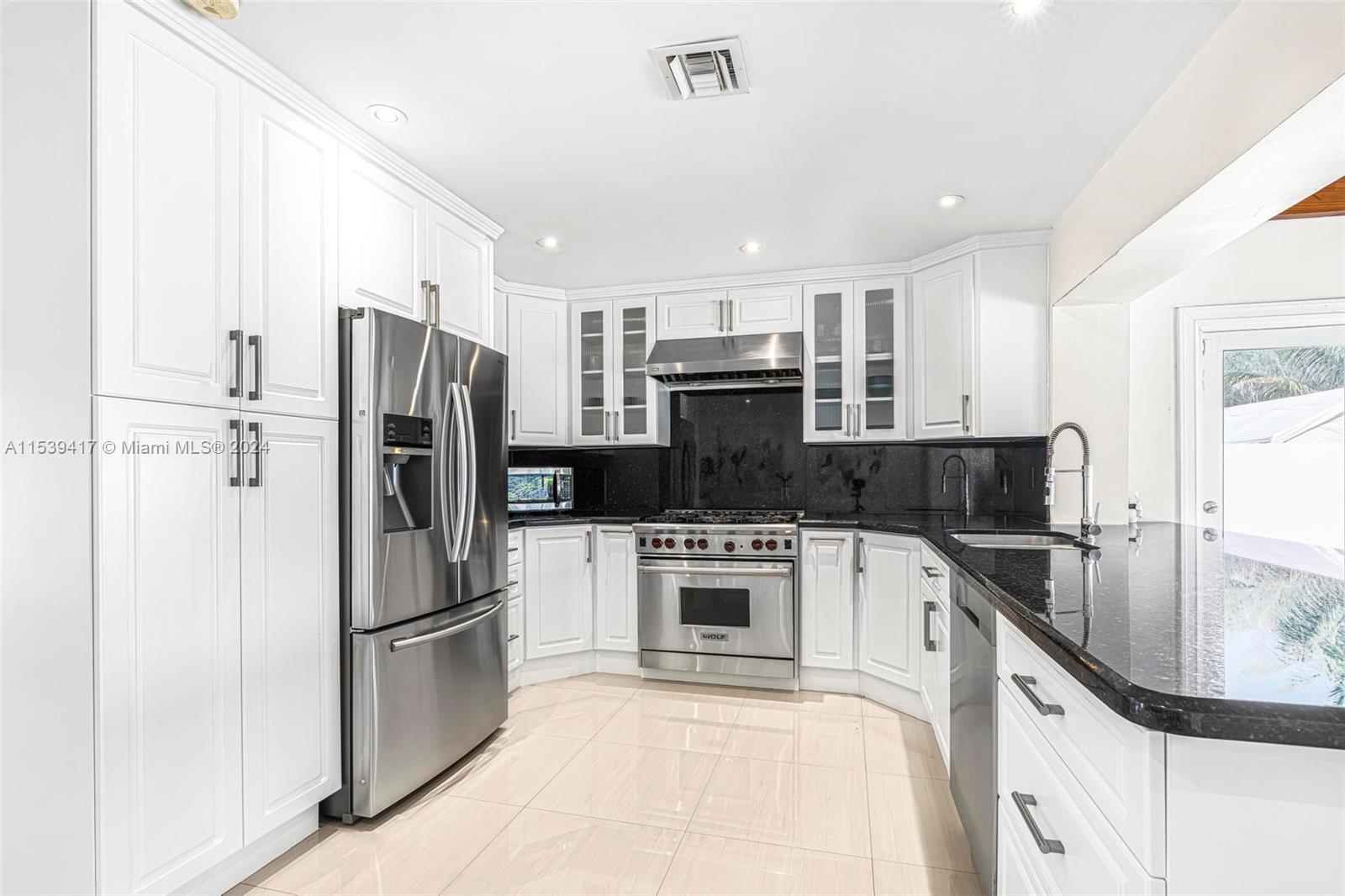 1301 Southwest 99th Court Miami, FL 33174 - Photo 8 of 35 a kitchen with a refrigerator sink and microwave