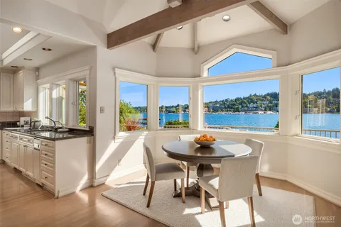 a kitchen with a stove a table and chairs in it