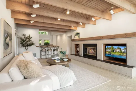 a living room with furniture a large window and a fireplace