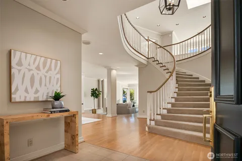 a view of entryway and hall with wooden floor