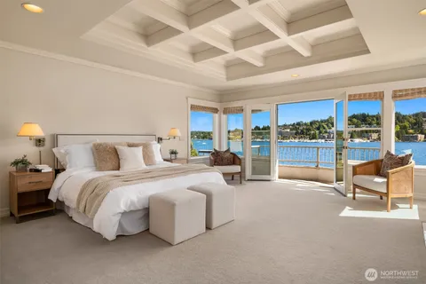 a spacious bedroom with a bed and large windows