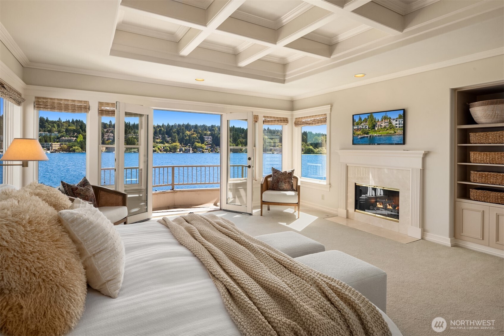 4640 95th Avenue Northeast Yarrow Point, WA 98004 - Photo 17 of 33 a spacious bedroom with a large bed and a fireplace with the outer view