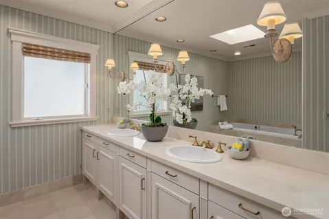 a bathroom with a sink a large mirror and a shower