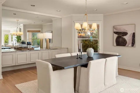 a kitchen with a table chairs sink and window