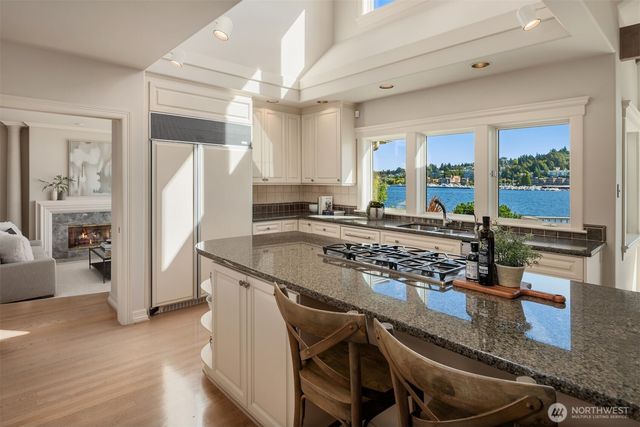 a kitchen with granite countertop a stove a refrigerator and a counter space