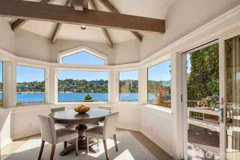 a dining room with furniture a chandelier and wooden floor